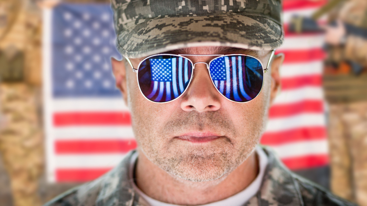 American patriot soldier concept over american flag background. soft daylight.