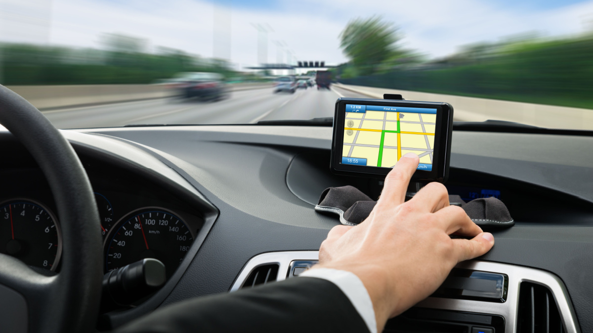 Close-up Of A Person's Hand Using Gps Navigation System In Car.