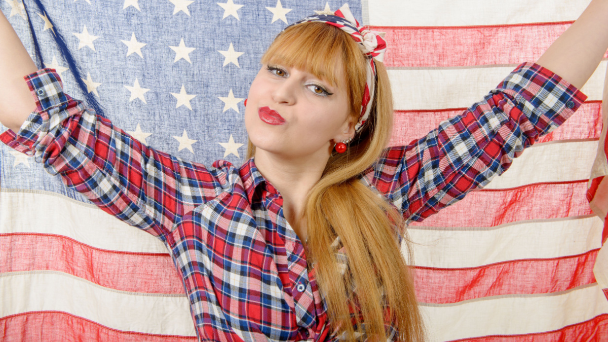 girl isolated holding an American Flag.