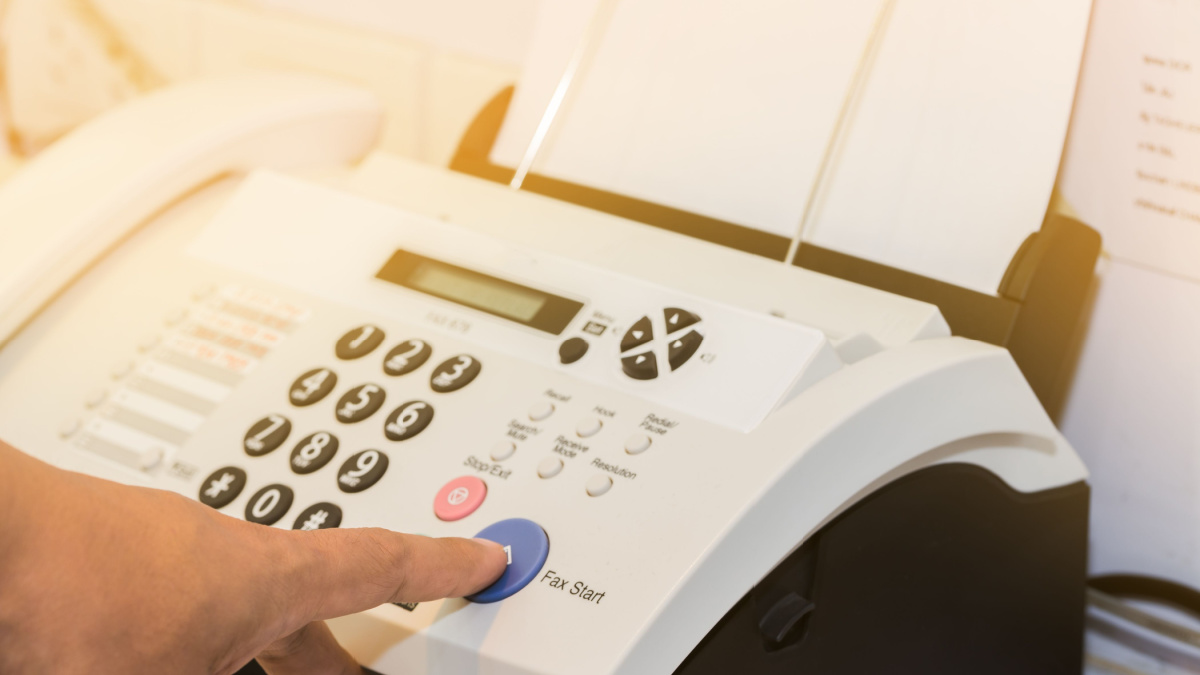 hand finger press transmitter fax send document is office equipment.