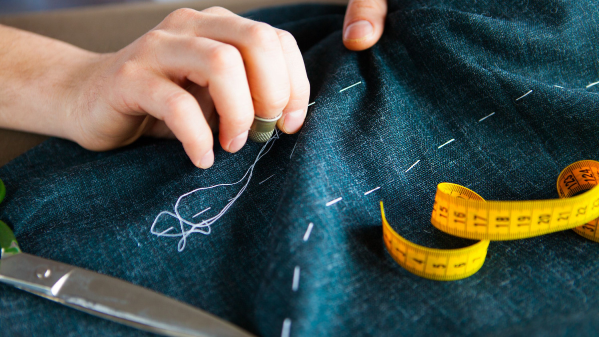 Tailor man working in his tailor shop, Tailoring, close up.