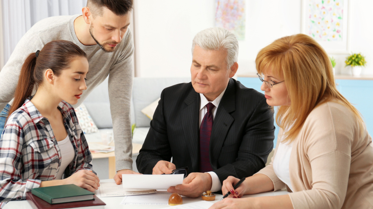 Family consulting notary public at office.