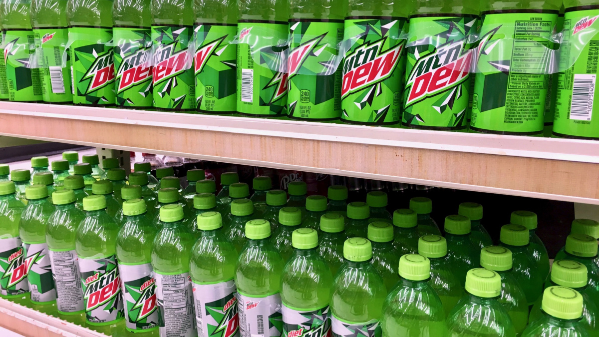 Mtn dew soda pop on the shelf at a grocery store in the soda isle.
