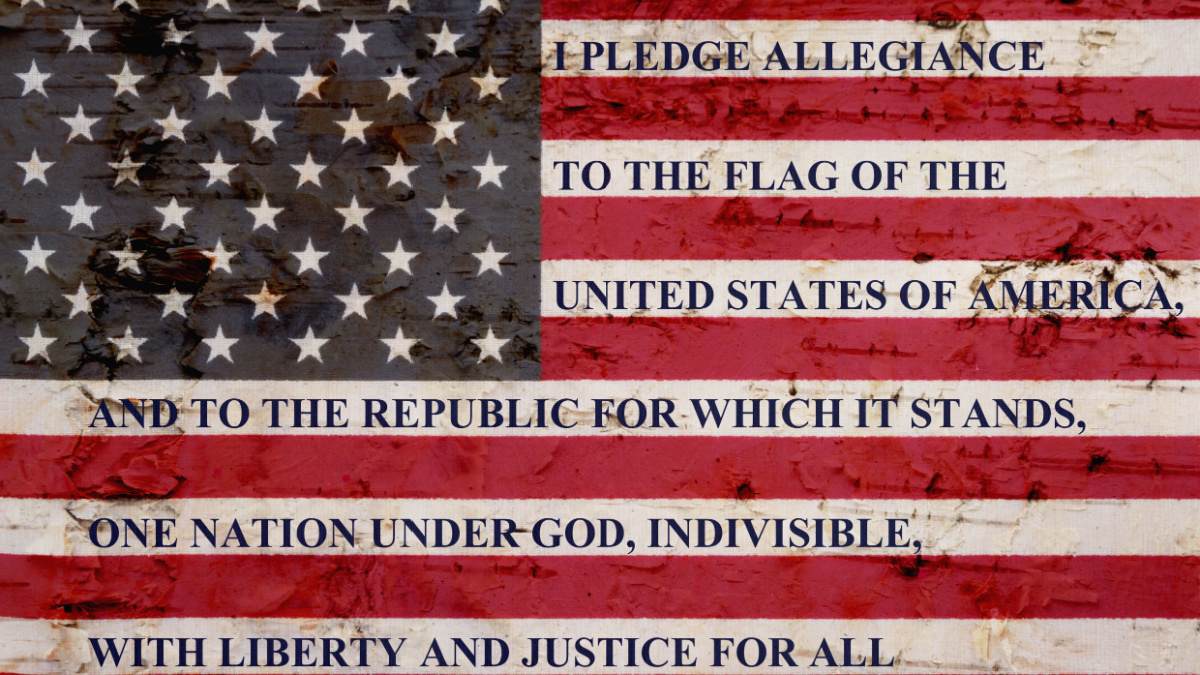 The pledge of allegiance written on a weathered United States of America flag.
