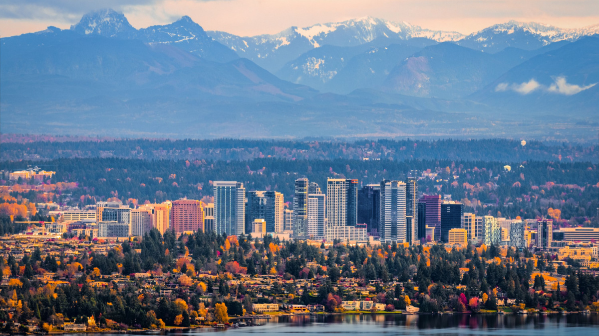 Bellevue Washington. The snowy Alpine Lakes Wilderness mountain peaks rise behind the urban skyline.
