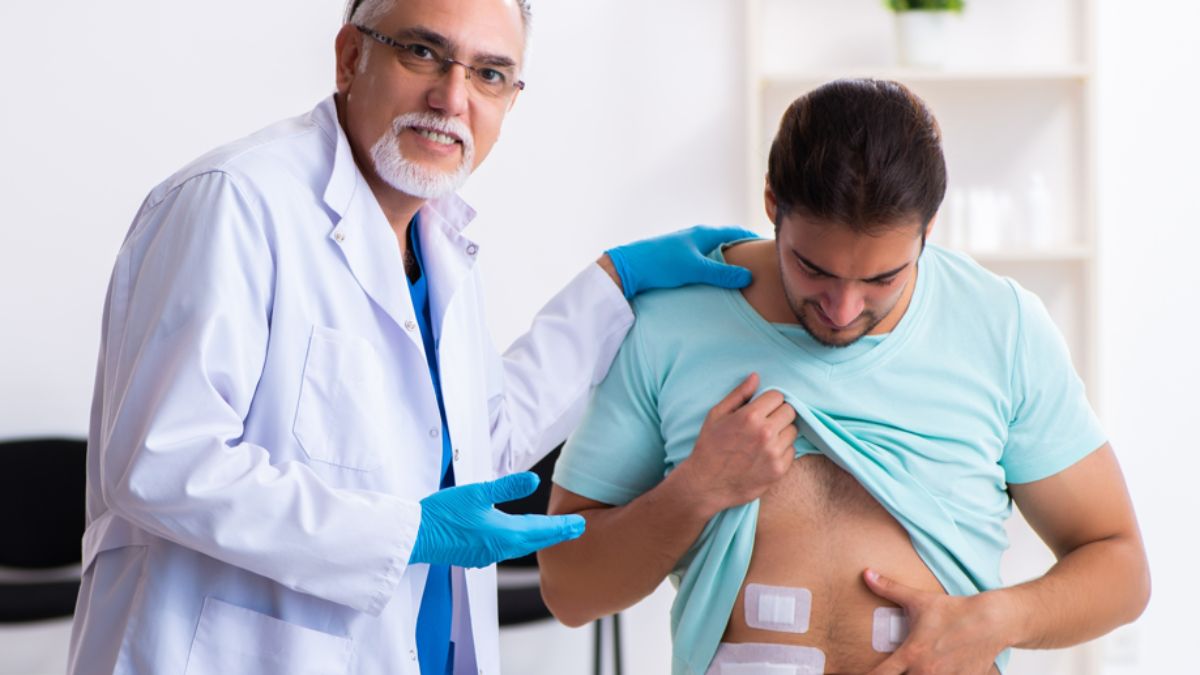 Injured young man visiting experienced male doctor