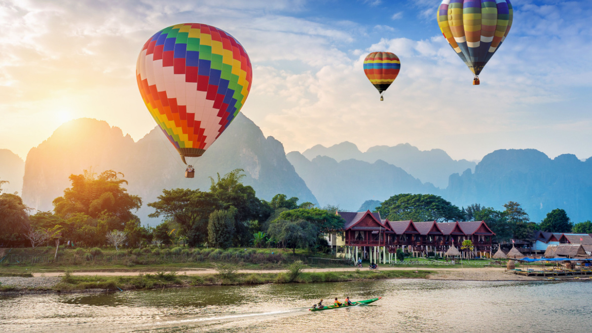 Hot air balloon over Nam Song river at sunset in Vang vieng, Laos.