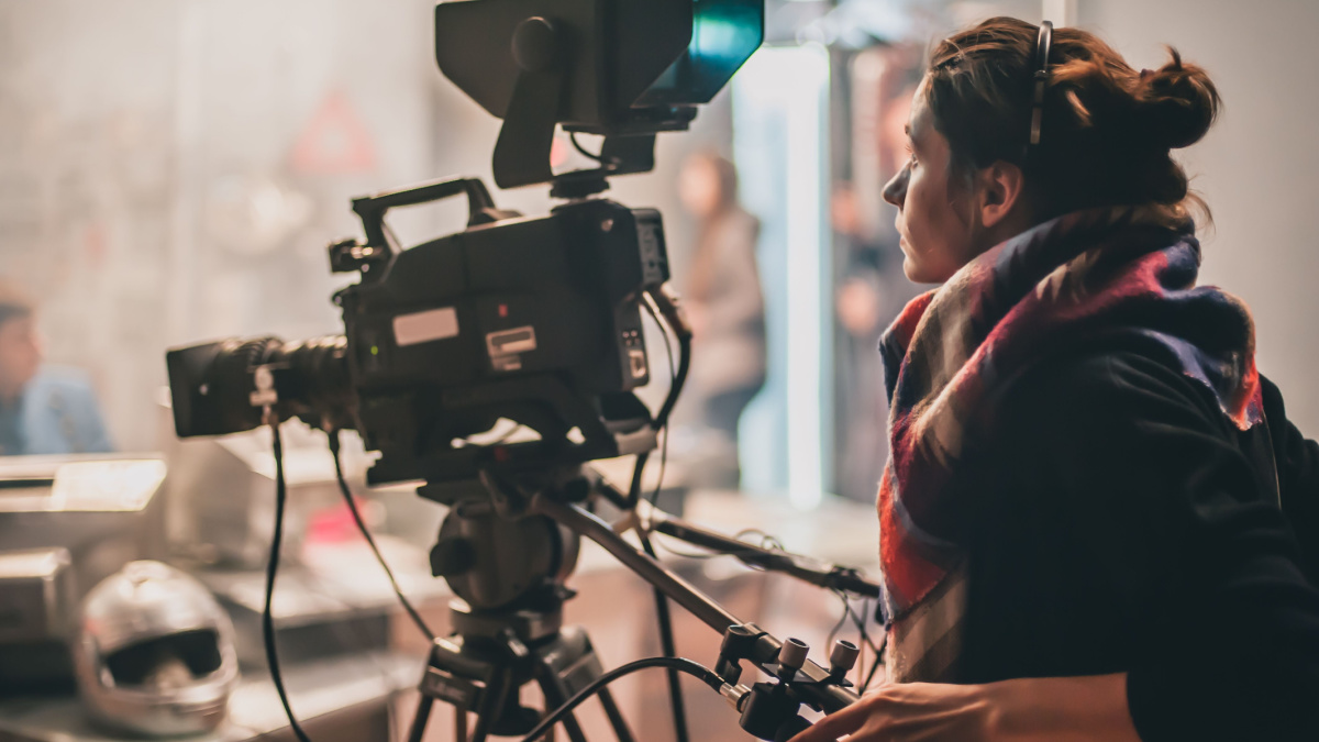 Behind the scene. Actor in front of the camera on the film set in film studio.