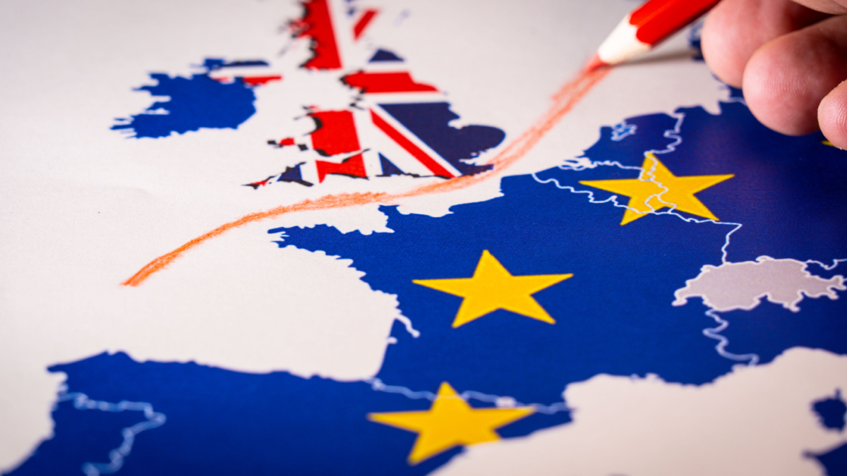 Hand drawing a red line between the UK and the rest of the European Union. Concept of Brexit. The UK is thus on course to leave the EU