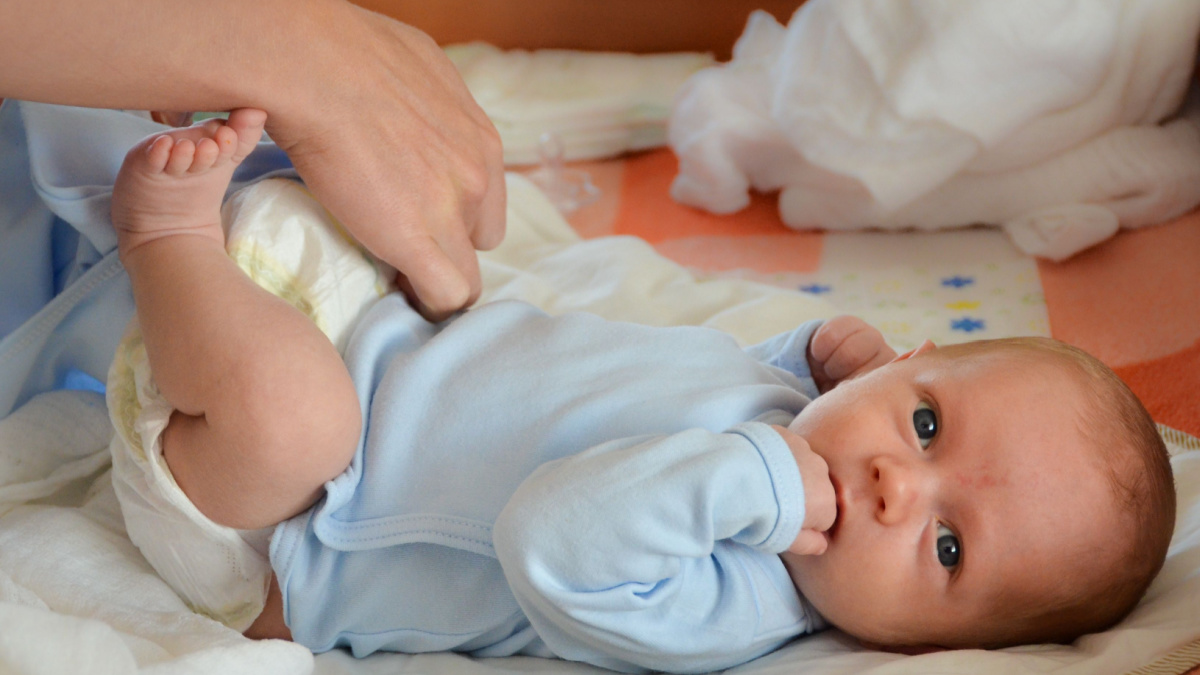 Mother changing the baby's nappy