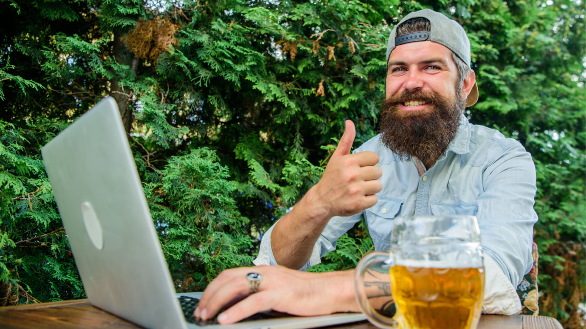 Guy sit terrace outdoors with beer. Betting and real money gaming. Brutal man leisure with beer and sport game.