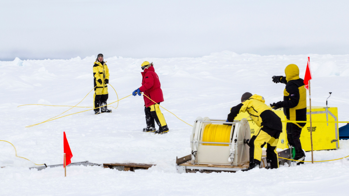 Weddell Sea, Antarctica – September 19, 2013: Scientists from a research icebreaker are establishing a remotely operated vehicle (ROV) camp over an ice floe to explore under ice algal growth