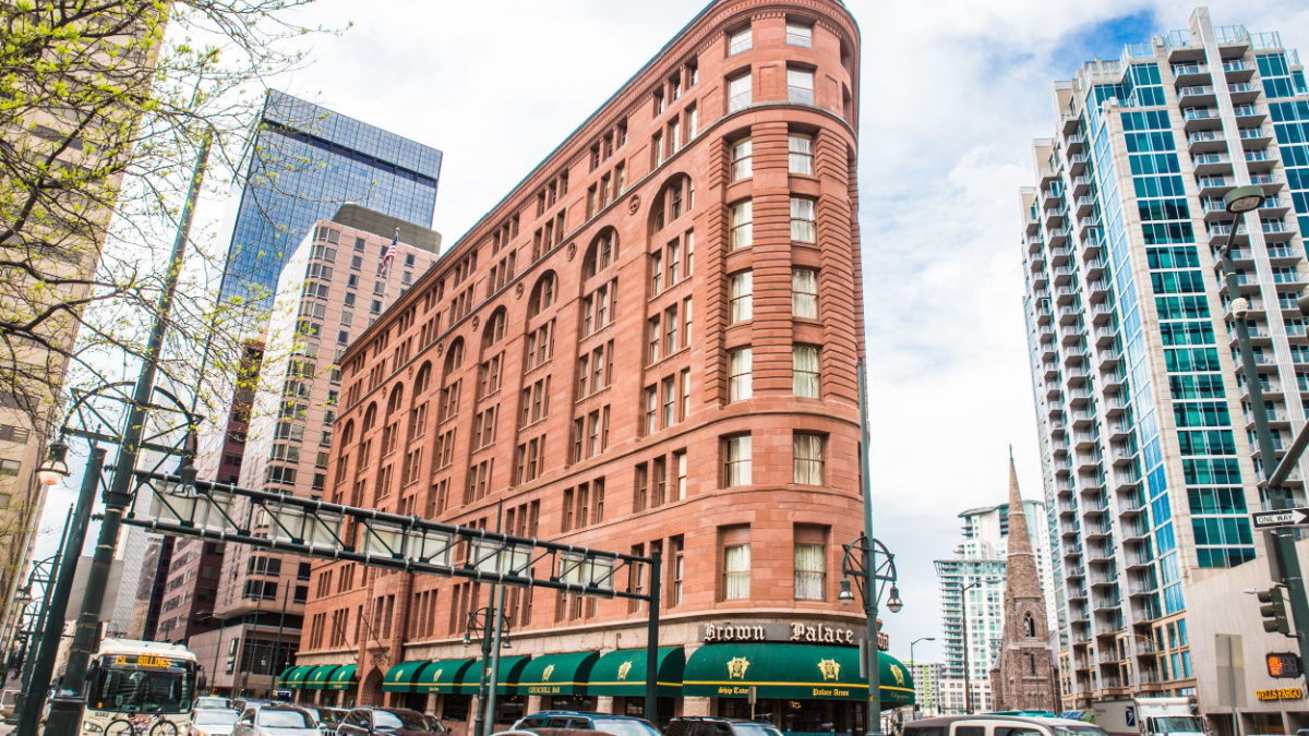 Street scene from the city of Denver Colorado with historic Brown Palace hotel and spa in view.