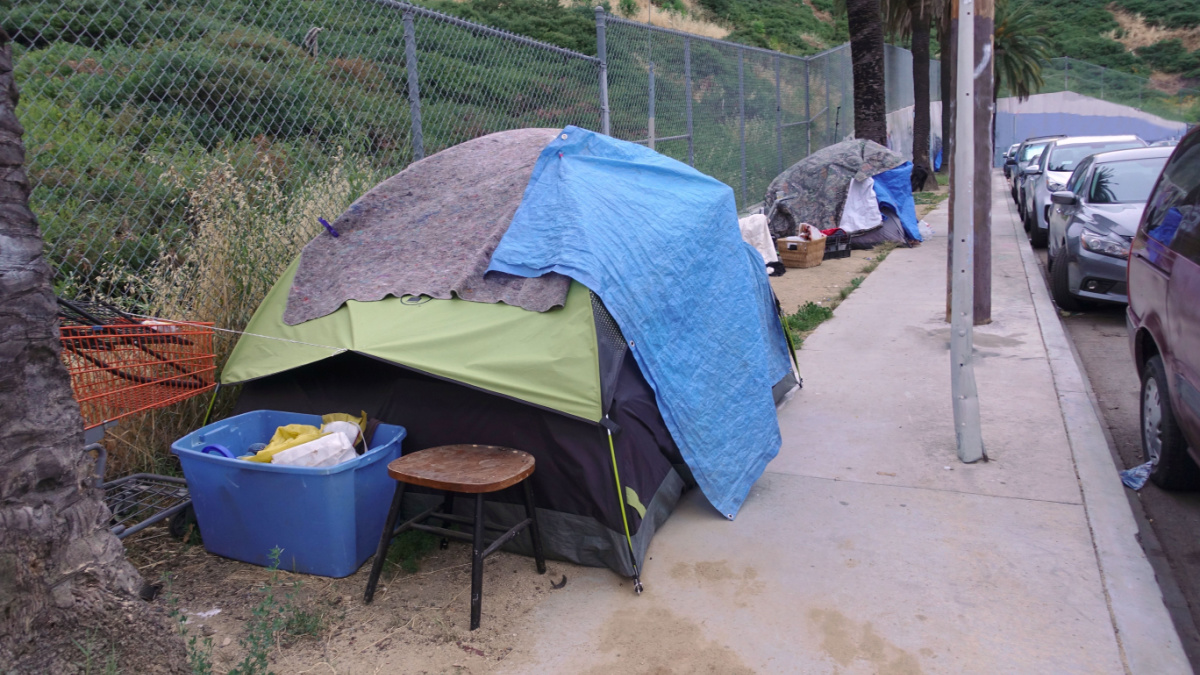 Homeless camp on a sidewalk in downtown Los Angeles, makeshift shelters made from tents and blankets. An issue that needs to be addressed.