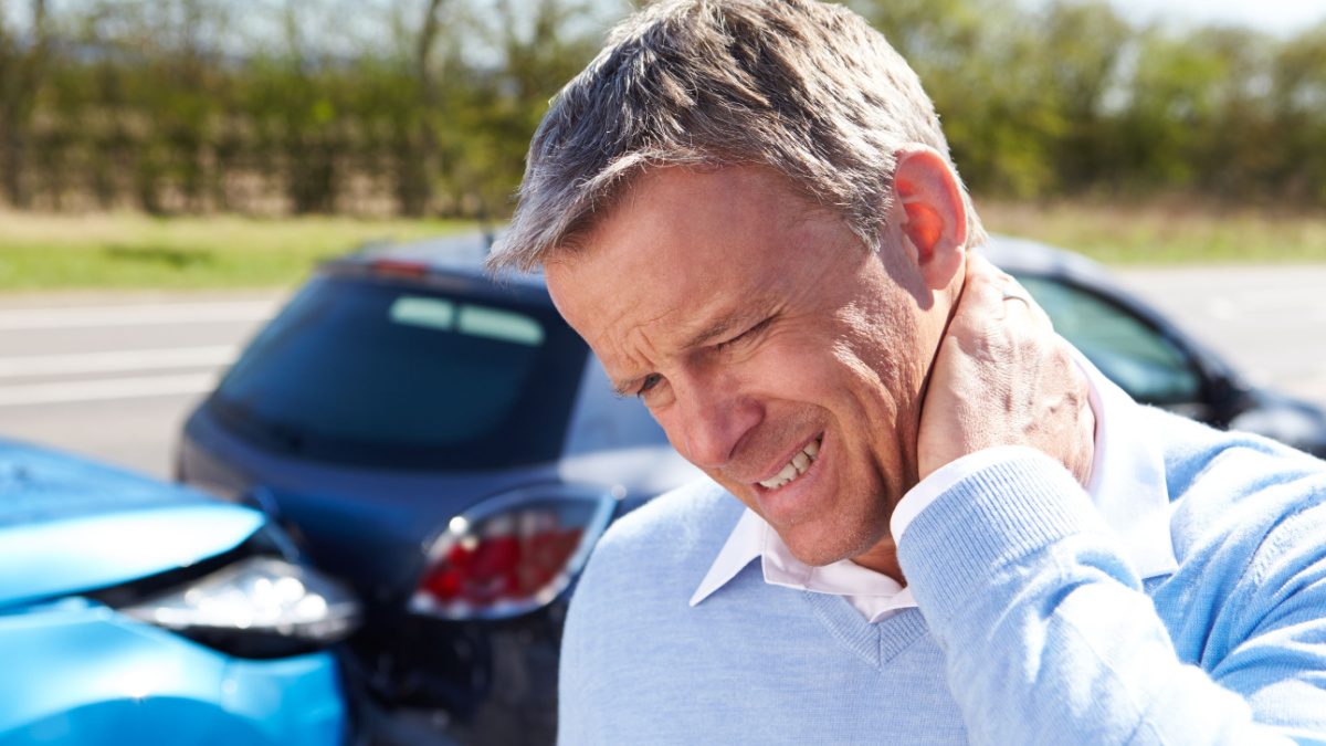 Driver Suffering From Whiplash After Traffic Collision.