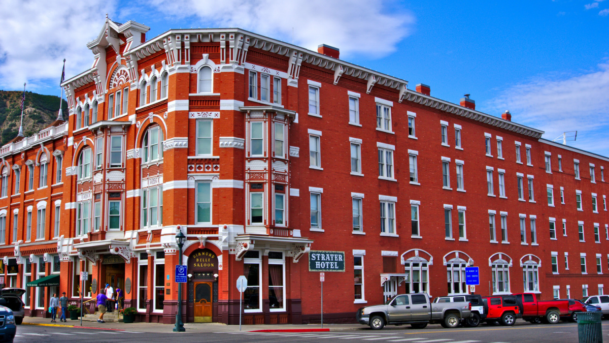 Strater Hotel North and East Street view. Cloudy day with blue sky.