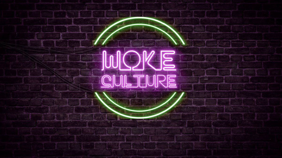 A green and purple neon light sign that reads: Woke Culture.