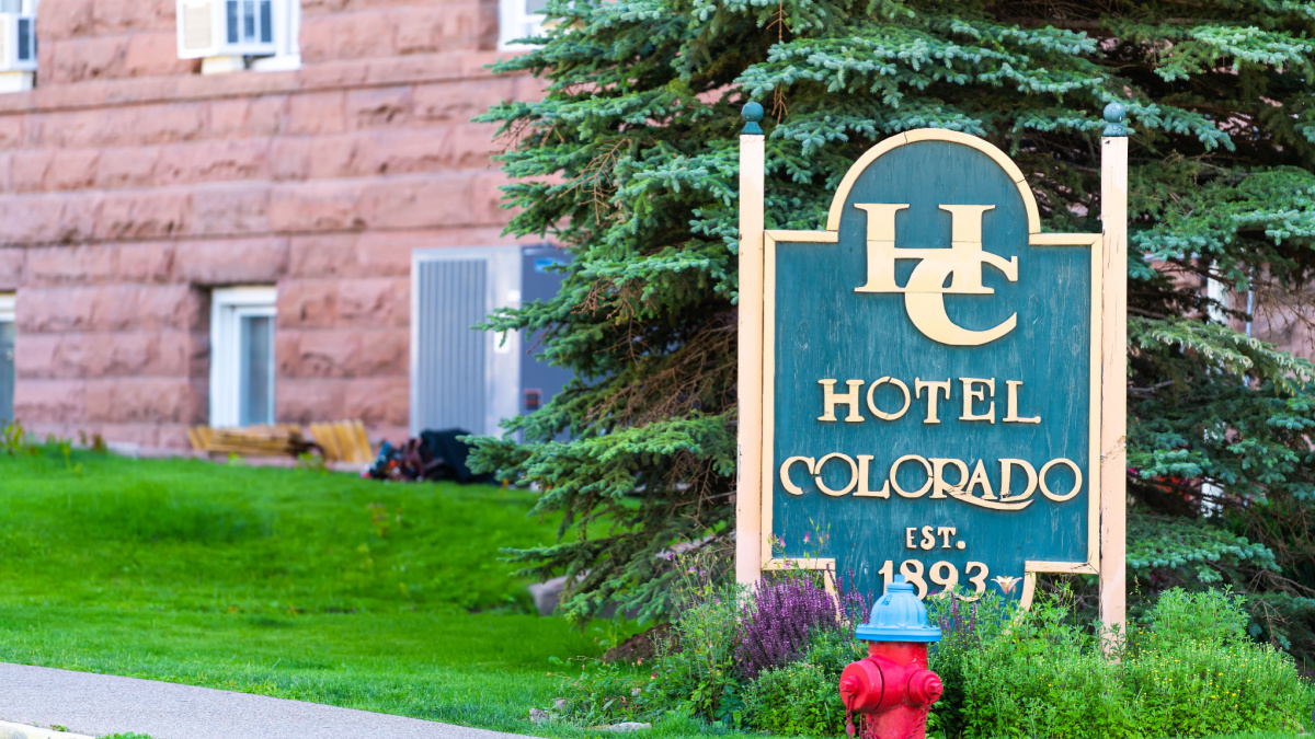 Historic downtown street with green sign for famous hotel Colorado