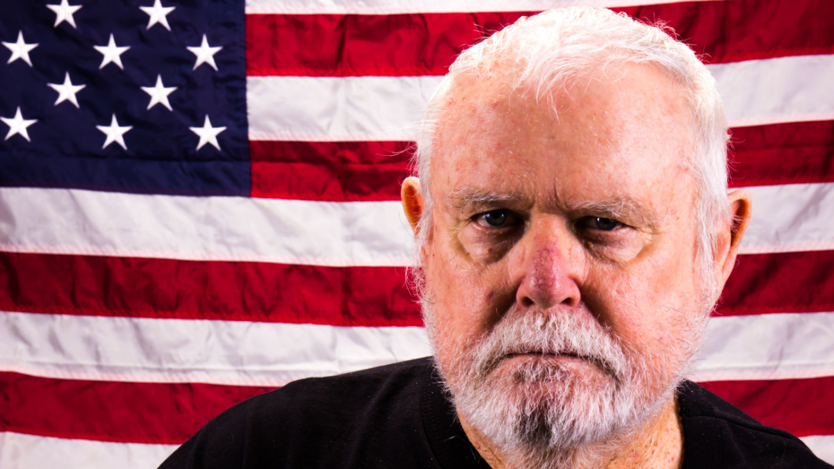 Suspicious Old Vietnam Vet In Front Of American Flag.