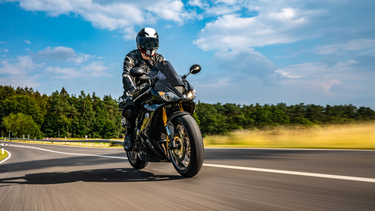 motorbike on the road riding. having fun driving the empty road on a motorcycle tour journey.