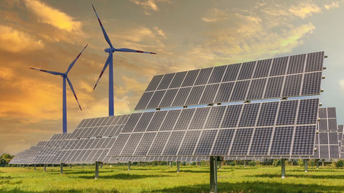 Solar panels wind turbines installed as renewable energy sources for electricity and power supply. Innovation and technology, environmental friendly energy. Solar farm under sunny day