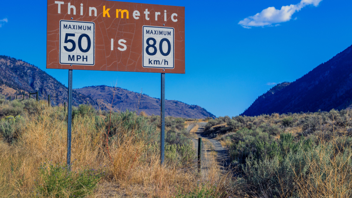 Metric to imperial measurement speed limit sign from miles per hour to kilometers per hour at the Nighthawk border crossing in British Columbia, Canada.