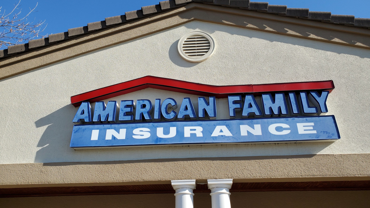 Sign for Local AMERICAN FAMILY INSURANCE Agency beneath Blue Sky