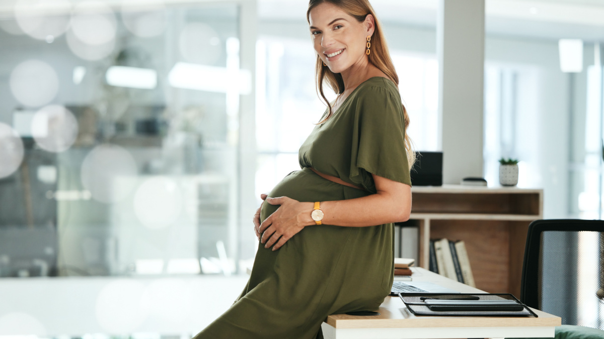 Portrait, belly and a pregnant woman in her business office at the start of her maternity leave from work. Company, smile and pregnancy with a happy young employee in the workplace for motherhood