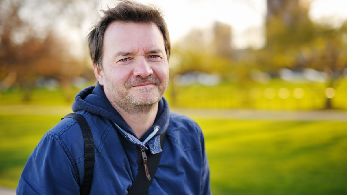 Outdoors portrait of middle age man at the spring, summer or autumn day.