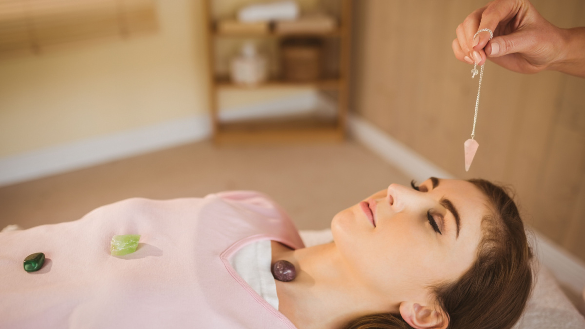 Young woman at crystal healing session in therapy room