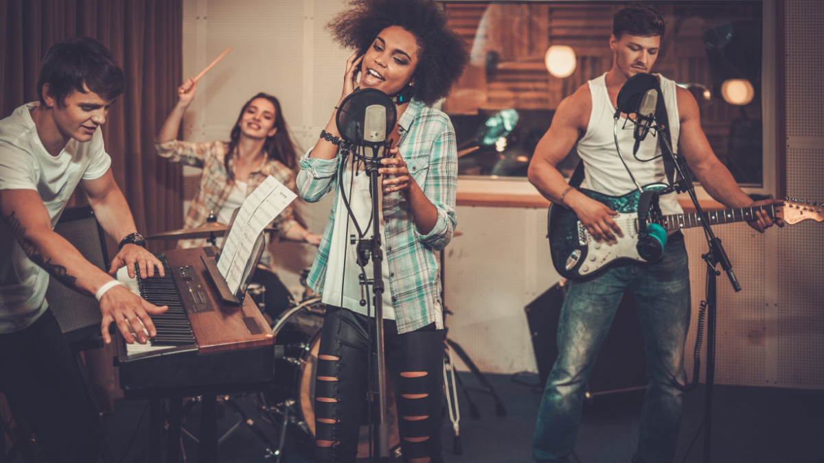 Multiracial music band performing in a recording studio