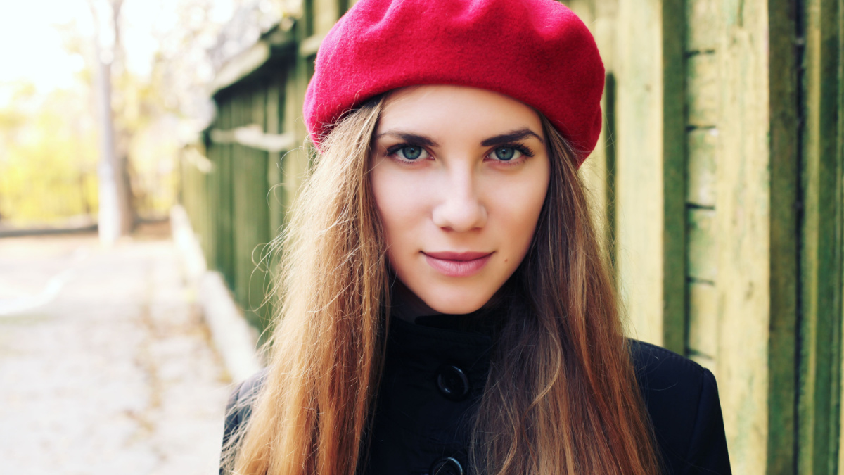 Elegant young Parisian woman outdoors. Beautiful charming girl in red beret. French Style.