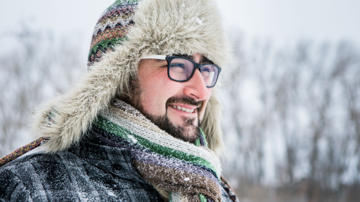 Adult man with beard wearing glasses..
