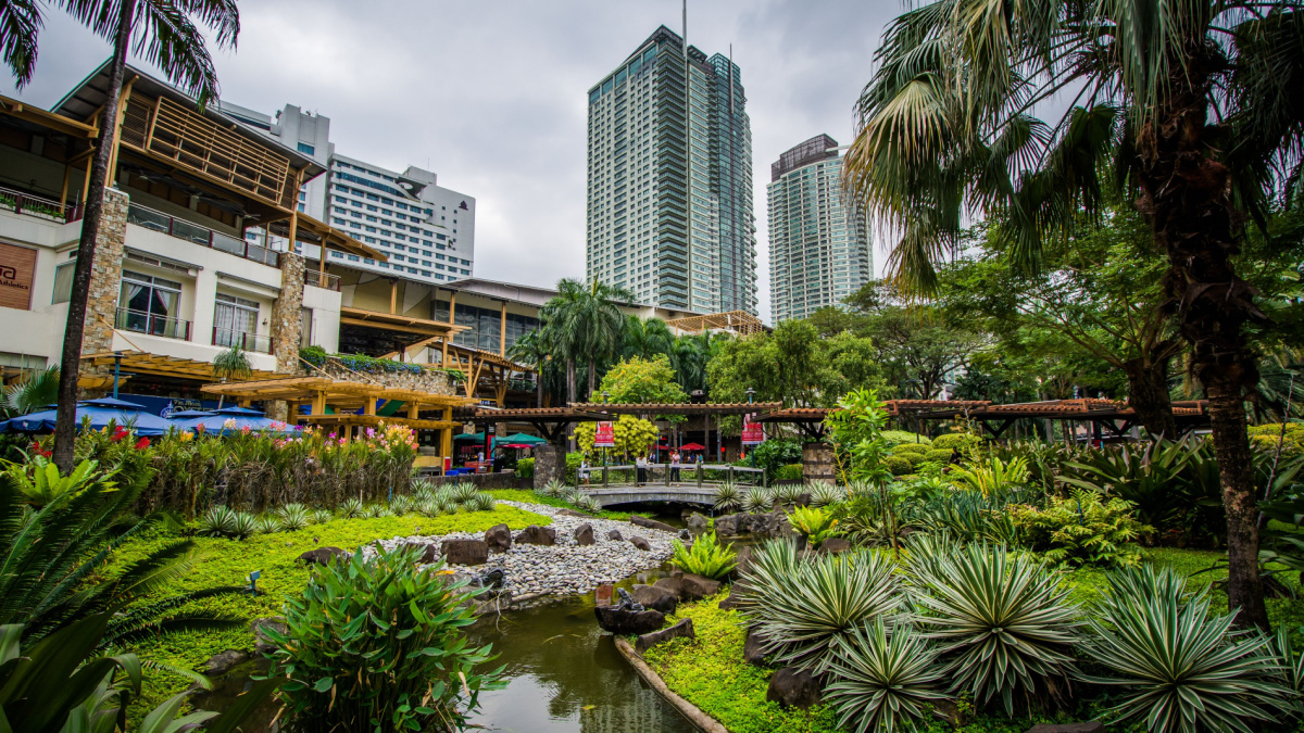 Gardens and skyscrapers at Greenbelt Park, in Ayala, Makati, Metro Manila, The Philippines.