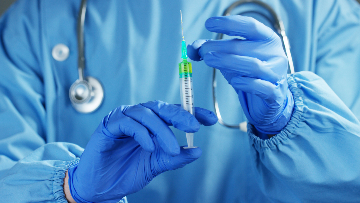 A doctor or scientist in laboratory holding a syringe with liquid vaccines for children or older adults, or cure animal diseases. Concept:diseases,medical care,science, anesthesia,euthanasia,diabetes.