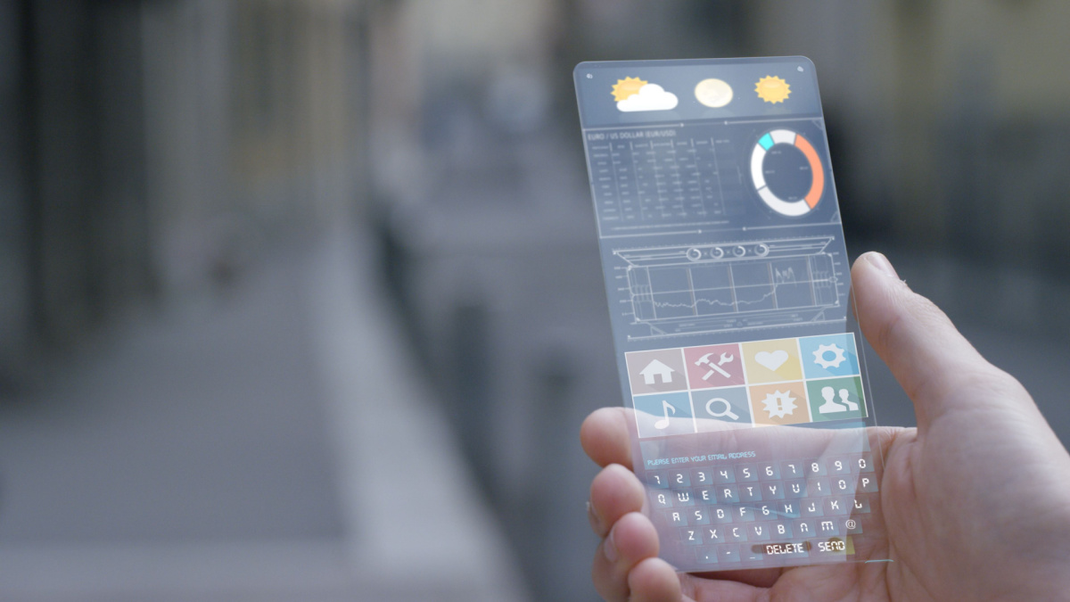 A man in the city, use the transparent phone with the latest technology with holography and watch the weather and the messages. Concept: technology, future and futuristic technology.