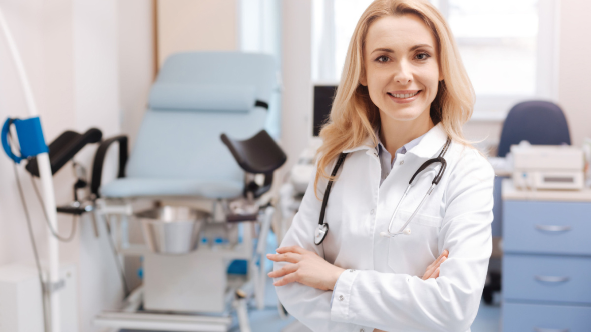 Cheerful gynecologist waiting for the next patient in the cabinet