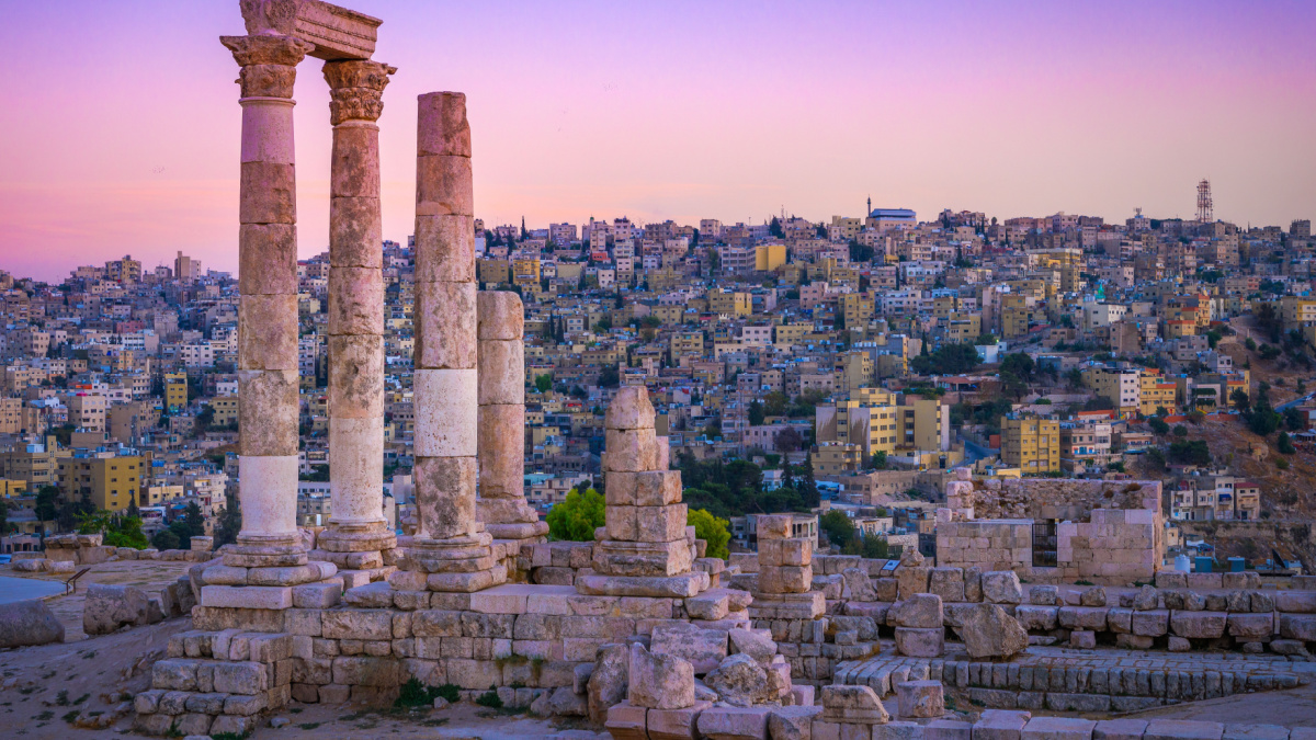 Amman, Jordan its Roman ruins in the middle of the ancient citadel park in the center of the city. Sunset on Skyline of Amman and old town of the city with nice view over historic capital of Jordan.