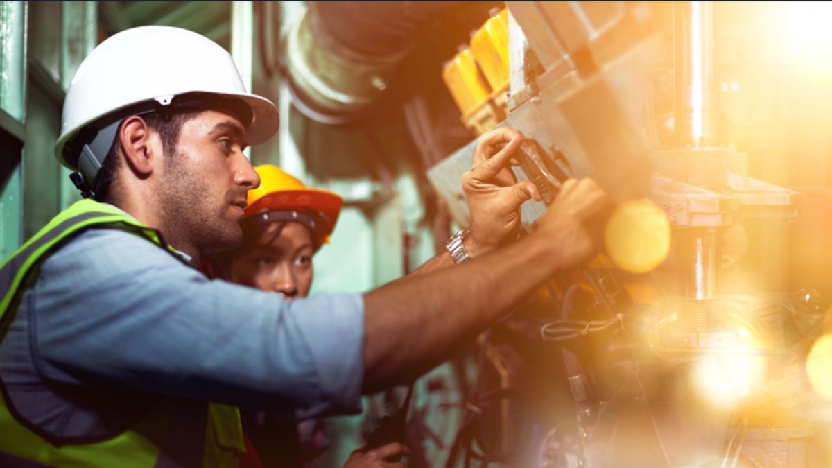 Industrial workers are working in the factory. Machine engineers or mechanical technicians and assistants are helping to repair and inspect the machine's readiness before the product is manufactured.