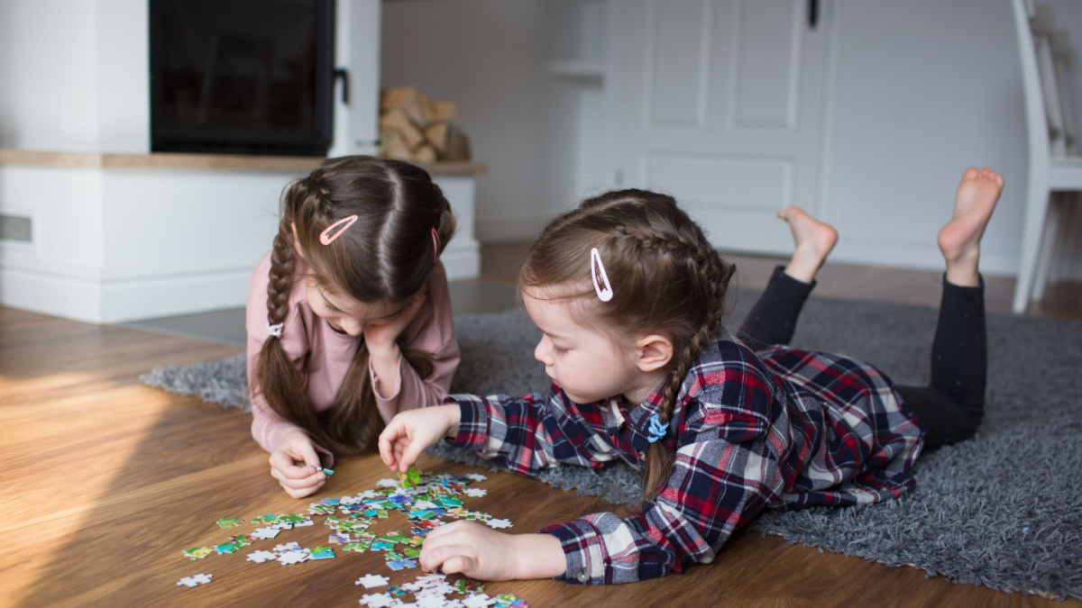 Children playing puzzles at home