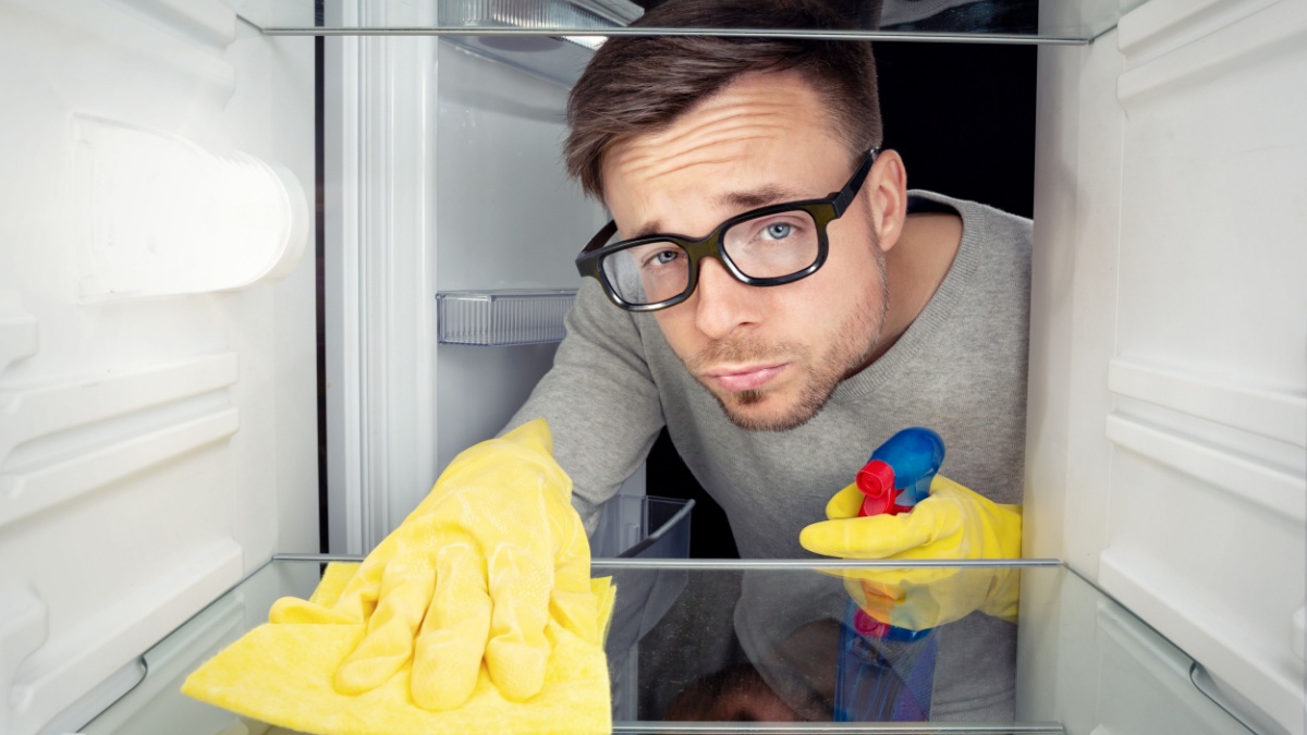Man cleaning the fridge.
