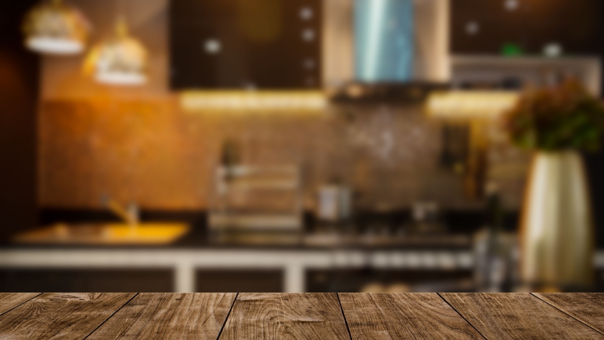 modern luxury kitchen black golden tone with wooden tabletop.