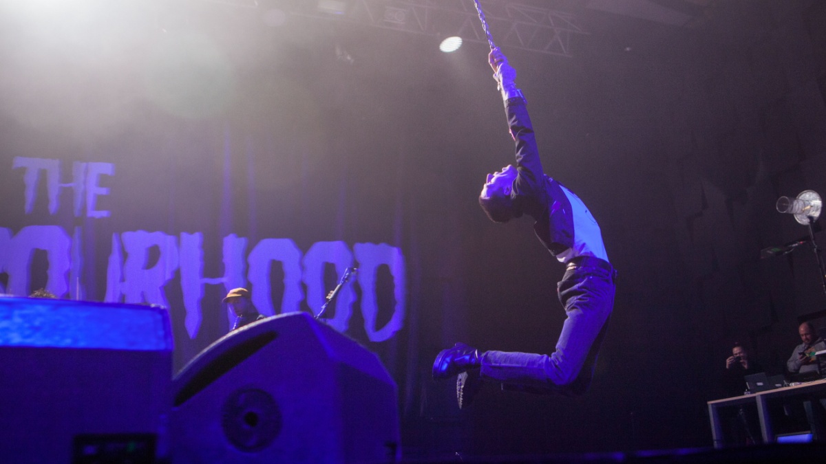 American singer Jesse Rutherford swings on a hanging microphone on a stage with his band The Neighbourhood at Forum Karlín in Prague, Czech Republic