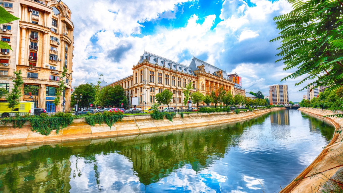 Antique building view in Old Town Bucharest city - capital of Romania and Dambrovita river. Bucharest, Romania, Europe.