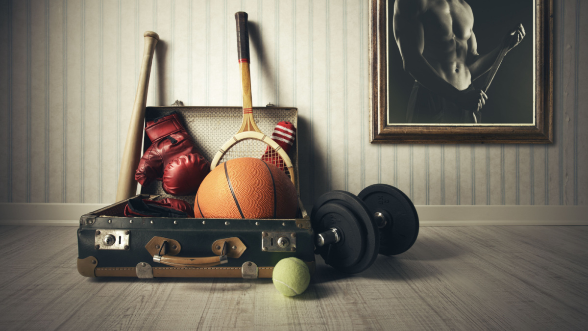 Old Suitcase with sports equipment and athlete photo