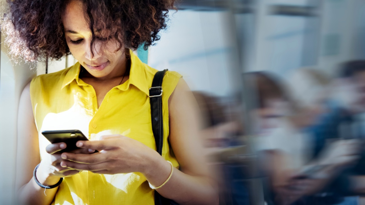 Young woman using a smartphone in a subway.