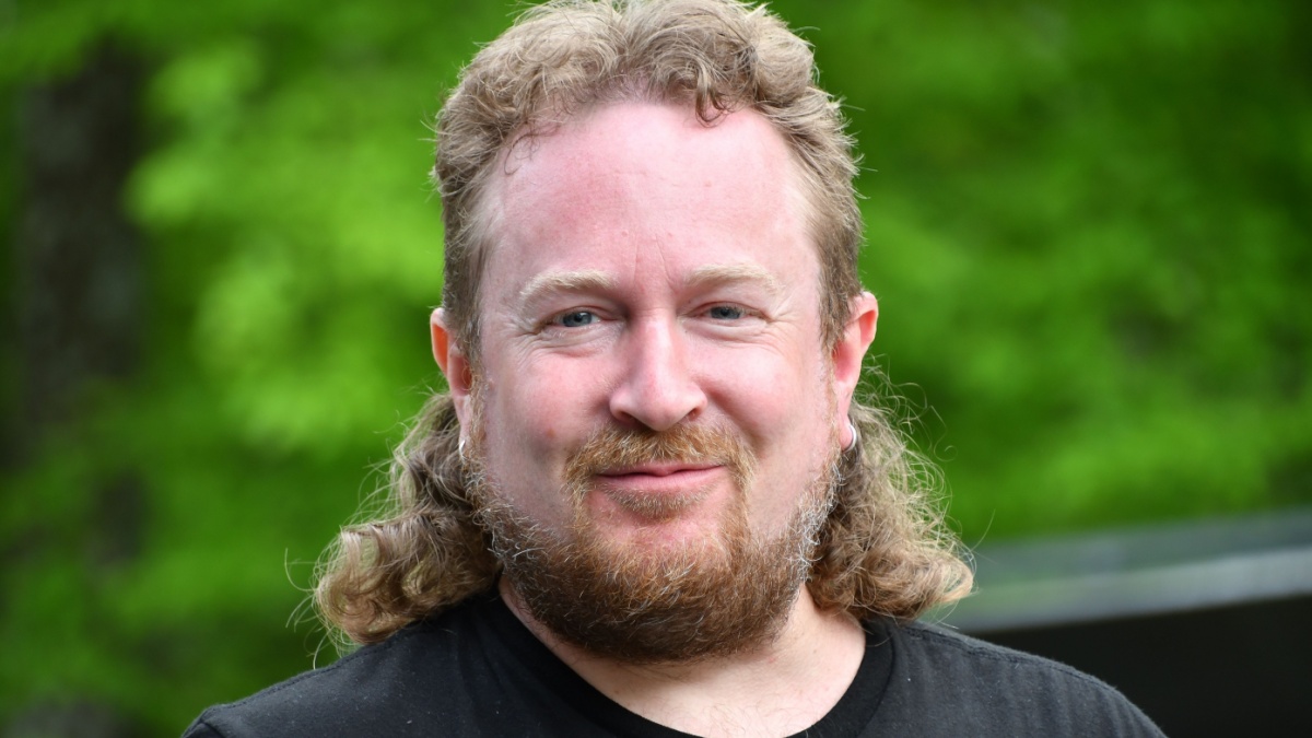 White man with mullet poses for portrait.