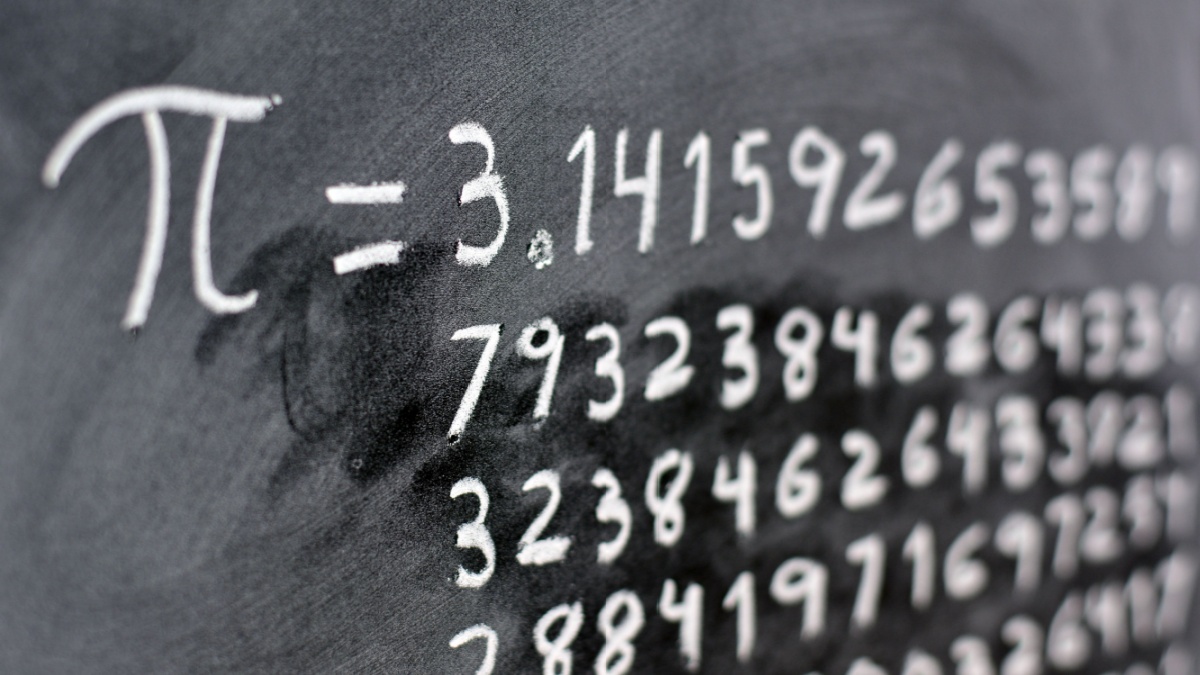 The number pi written with chalk on the blackboard, with its equivalence in numbers
