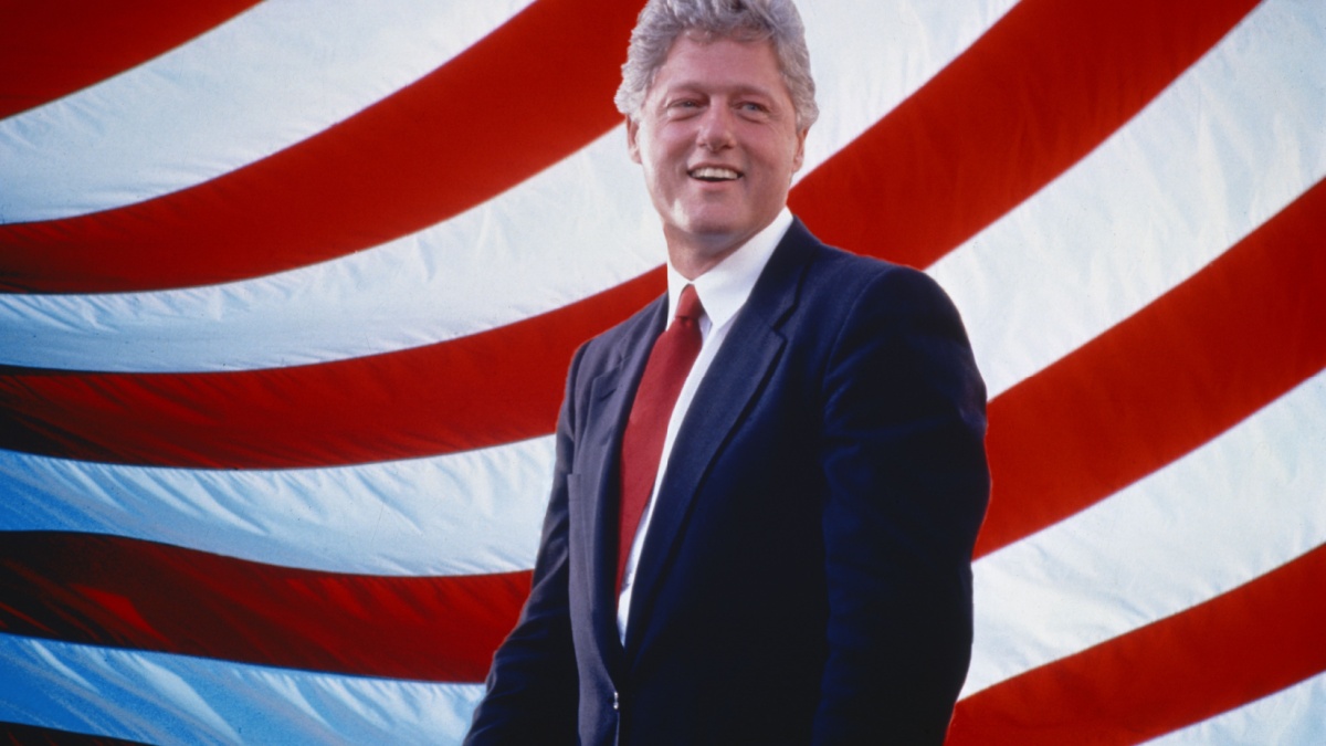 President William Jefferson Clinton in front of American flag stripes