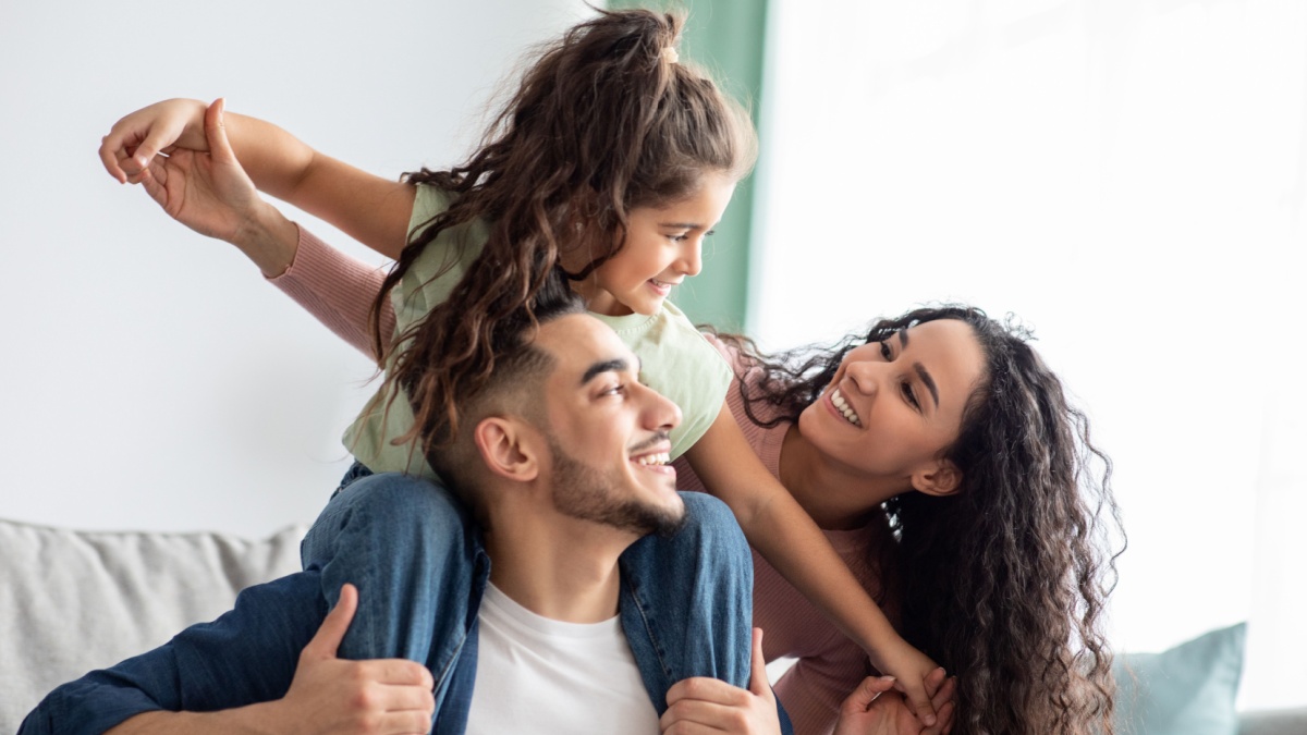 Cheerful Middle Eastern Family Of Three Having Fun Together At Home.